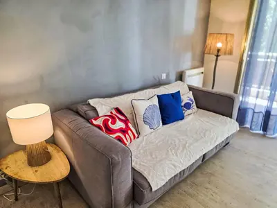 a couch with pillows on it in a living room at Apartment Villa Lerins-8 by Interhome in Cannes