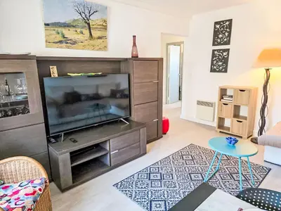 a living room with a large flat screen tv at Apartment La Chaumière by Interhome in Cannes