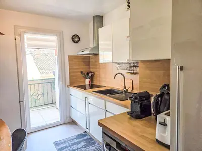 a kitchen with white cabinets and a sink and a window at Apartment La Chaumière by Interhome in Cannes