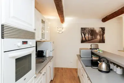 a kitchen with white cabinets and a counter top at Le Meynadier Center-Festival-Clim-WiFi in Cannes