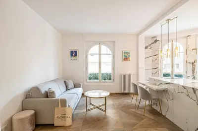 a living room with a couch and a table at LE PASTEUR pour tout confort en plein cœur de Cannes in Cannes