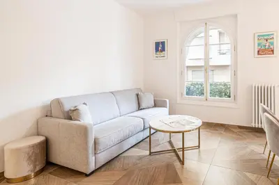 a living room with a couch and a table at LE PASTEUR pour tout confort en plein cœur de Cannes in Cannes