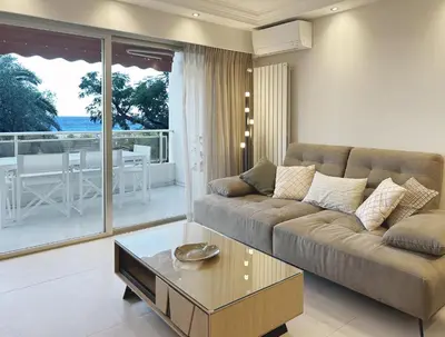 a living room with a couch and a coffee table at Elegant 2 Br with parking in Cannes