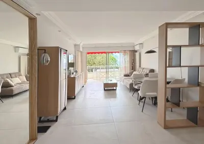 a living room with a couch and a table at Elegant 2 Br with parking in Cannes