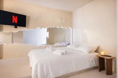a white bedroom with a bed and a bath tub at Caldera - SPA & Climatisation & Proche Croisette in Cannes