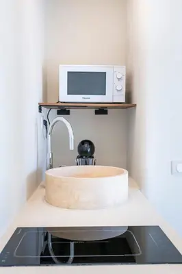 a bathroom counter with a sink and some paper towels at Caldera - SPA & Climatisation & Proche Croisette in Cannes