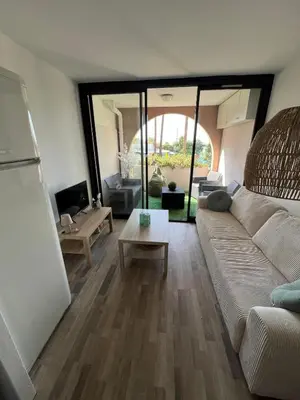 a living room with a couch and a table at Appartement 2 pièces Cannes - Piscine - Plages in Cannes