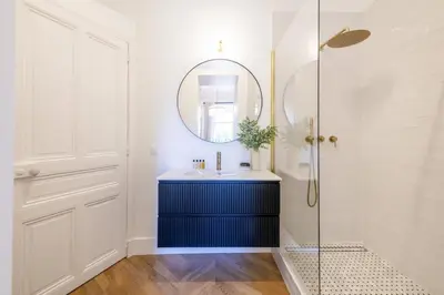 a bathroom with a sink and a mirror at LB Vacation Rentals I Luxurious 1BR with parking & terrace in Cannes