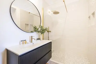 a bathroom with a sink and a mirror at LB Vacation Rentals I Luxurious 1BR with parking & terrace in Cannes