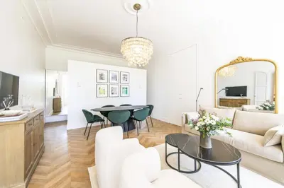 a living room with a couch and a table at LB Vacation Rentals I Luxurious 1BR with parking & terrace in Cannes
