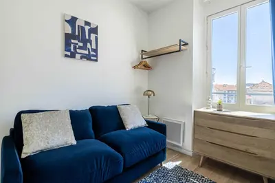 a living room with a couch and a table at Renovated cozy studio in Cannes - 2 persons in Cannes