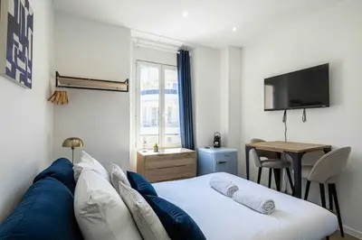 a white bathroom with a sink and a shower at Renovated cozy studio in Cannes - 2 persons in Cannes
