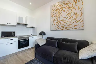 a living room with a desk and a bed and a window at Renovated cozy studio in Cannes - 2 persons in Cannes