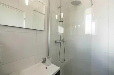 a hotel room with a bed and a bathroom at Renovated cozy studio in Cannes - 2 persons in Cannes
