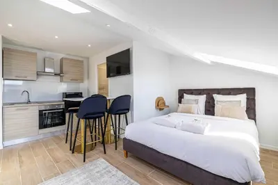 a kitchen with a table and chairs and a sink at Renovated cozy studio in Cannes - 2 persons in Cannes