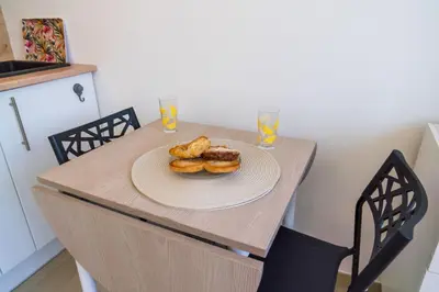a table with a plate of pastries on it at Studette Croisette, proche Martinez in Cannes