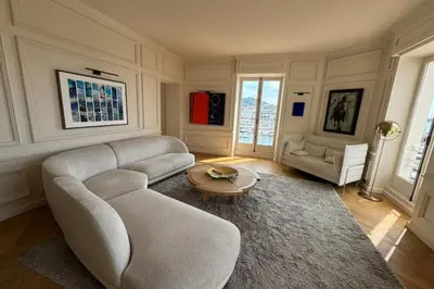 a living room with a couch and a table at Brand-new 100 sqm apartment with breathtaking panoramic views over Cannes’ in Cannes