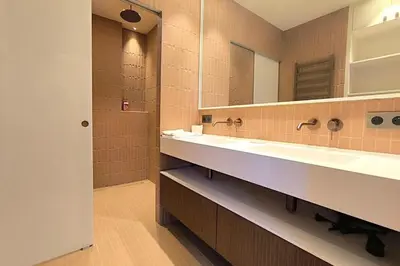 a bathroom with two sinks and a mirror at Brand-new 100 sqm apartment with breathtaking panoramic views over Cannes’ in Cannes