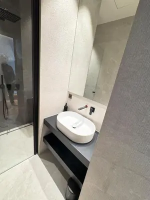 a bathroom with a white sink and a shower at Brand-new 100 sqm apartment with breathtaking panoramic views over Cannes’ in Cannes