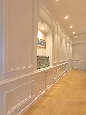 a hallway with white walls and a hardwood floor at Brand-new 100 sqm apartment with breathtaking panoramic views over Cannes’ in Cannes