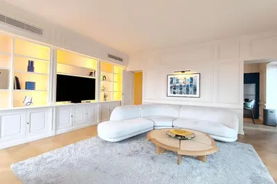 a living room with a white couch and a table at Brand-new 100 sqm apartment with breathtaking panoramic views over Cannes’ in Cannes
