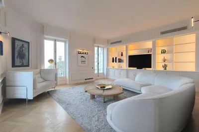 a living room with a couch and a table at Brand-new 100 sqm apartment with breathtaking panoramic views over Cannes’ in Cannes