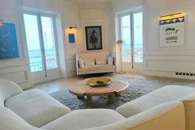a living room with two couches and a table at Brand-new 100 sqm apartment with breathtaking panoramic views over Cannes’ in Cannes