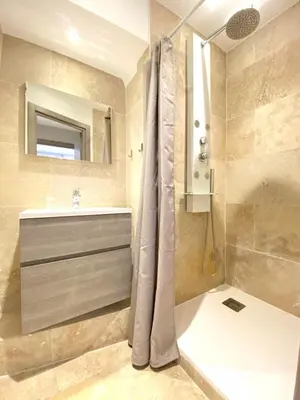 a bathroom with a shower and a sink and a tub at Stylish 2 Bed Apartment 1 Min to Palais & Beach in Cannes