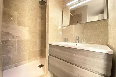 a bathroom with a sink and a mirror at Stylish 2 Bed Apartment 1 Min to Palais & Beach in Cannes