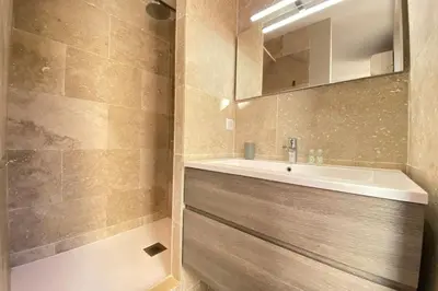 a bathroom with a sink and a mirror at Stylish 2 Bed Apartment 1 Min to Palais & Beach in Cannes