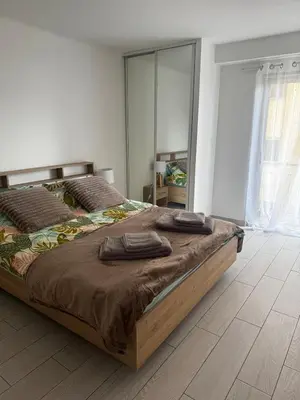 a bedroom with a large bed with two pillows on it at 3-room apartment with sea view in Cannes in Cannes