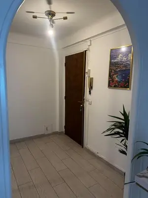 an arched hallway with a door and a plant at 3-room apartment with sea view in Cannes in Cannes