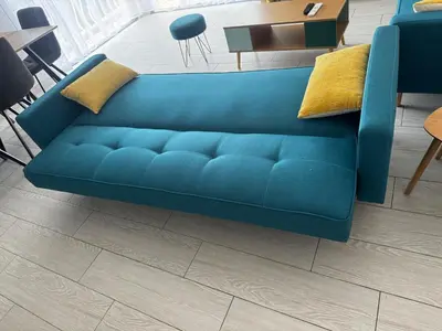 a blue couch sitting in a living room at 3-room apartment with sea view in Cannes in Cannes
