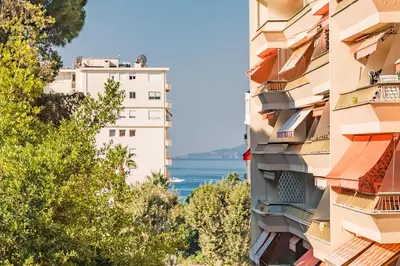 a view of the water from between two buildings at Studio rénové avec grande terrasse - Climatisation - Aperçu mer in Cannes