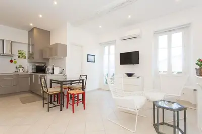 a kitchen and living room with a table and chairs at Mont Chevalier by Welcome to Cannes in Cannes
