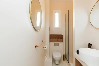 a bathroom with a toilet and a sink and mirrors at Yello YourHostHelper in Cannes