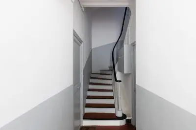 a hallway with a staircase with white walls and a stair case at Yello YourHostHelper in Cannes