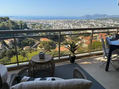 a balcony with a view of a city at Stunning 3-Room with Panoramic Views Over Cannes in Le Cannet