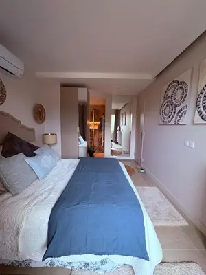 a bedroom with a large bed with a blue blanket at Stunning 3-Room with Panoramic Views Over Cannes in Le Cannet