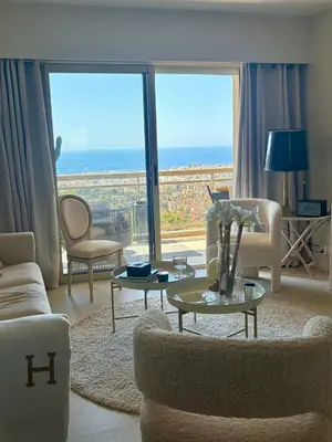 a living room with a view of the ocean at Stunning 3-Room with Panoramic Views Over Cannes in Le Cannet