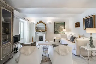 a living room with white furniture and a fireplace at Charme et confort à Cannes près de la Croisette in Cannes