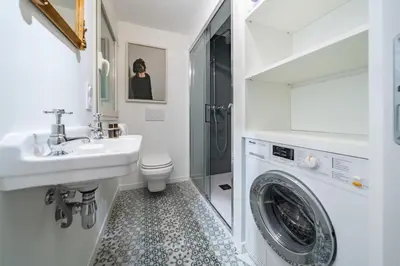 a bathroom with a sink and a washing machine at Charme et confort à Cannes près de la Croisette in Cannes
