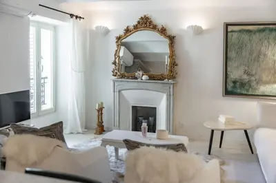 a living room with a mirror and a fireplace at Charme et confort à Cannes près de la Croisette in Cannes