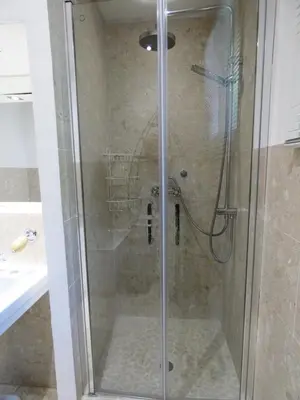a shower with a glass door in a bathroom at Cannes - LE DOLCE appartement de charme - 3 chambres - piscine in Cannes