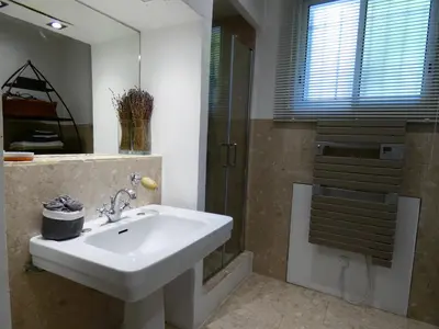 a bathroom with a sink and a shower at Cannes - LE DOLCE appartement de charme - 3 chambres - piscine in Cannes
