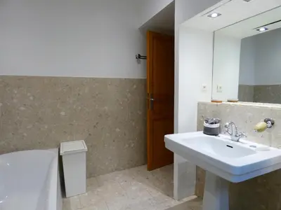 a bathroom with a sink and a mirror at Cannes - LE DOLCE appartement de charme - 3 chambres - piscine in Cannes
