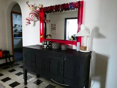 a black dresser in a room with a mirror at Cannes - LE DOLCE appartement de charme - 3 chambres - piscine in Cannes