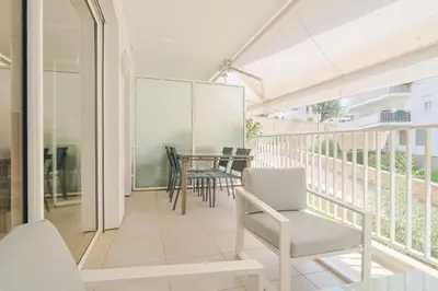 a balcony with white chairs and a table at Le Maria by Winsome Destination in Cannes