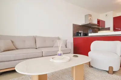 a living room with a couch and a table at Le Maria by Winsome Destination in Cannes