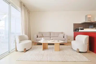 a living room with a couch and two chairs and a table at Le Maria by Winsome Destination in Cannes